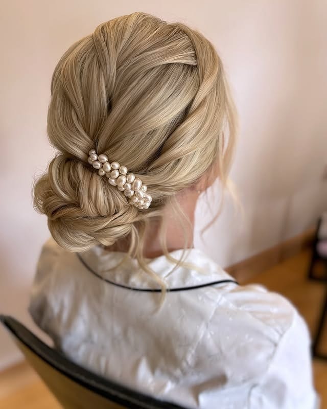 10. Elegant Twisted Low Bun with Pearl Accent on Light Blonde Hair - Bridesmaid Hairstyles