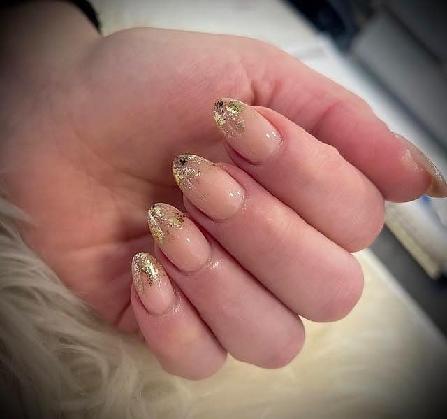 2. Soft Honey Blonde Waves with Gold Foil Almond Nails - gold glitter nail ideas