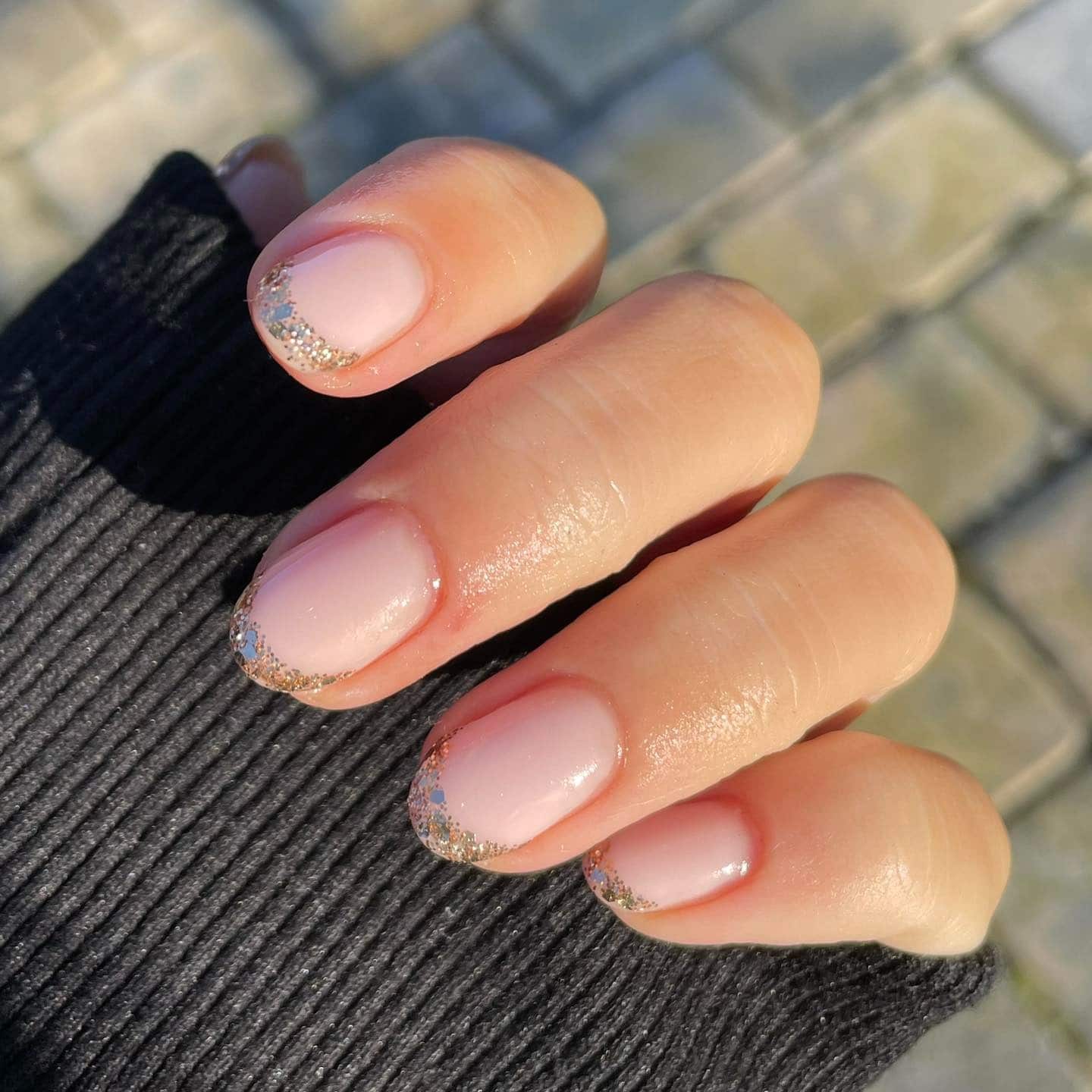 7. Natural Dark Brown Hair with Subtle Gold French Tips - gold glitter nail ideas