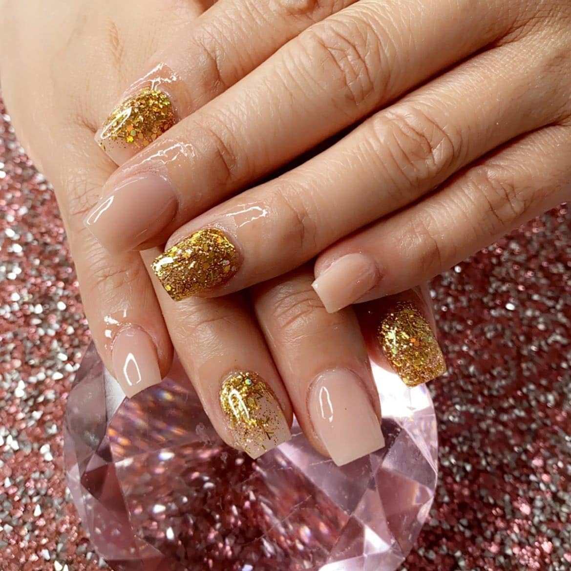 8. Golden Blonde Balayage with Chunky Gold Glitter Accent Nails - gold glitter nail ideas