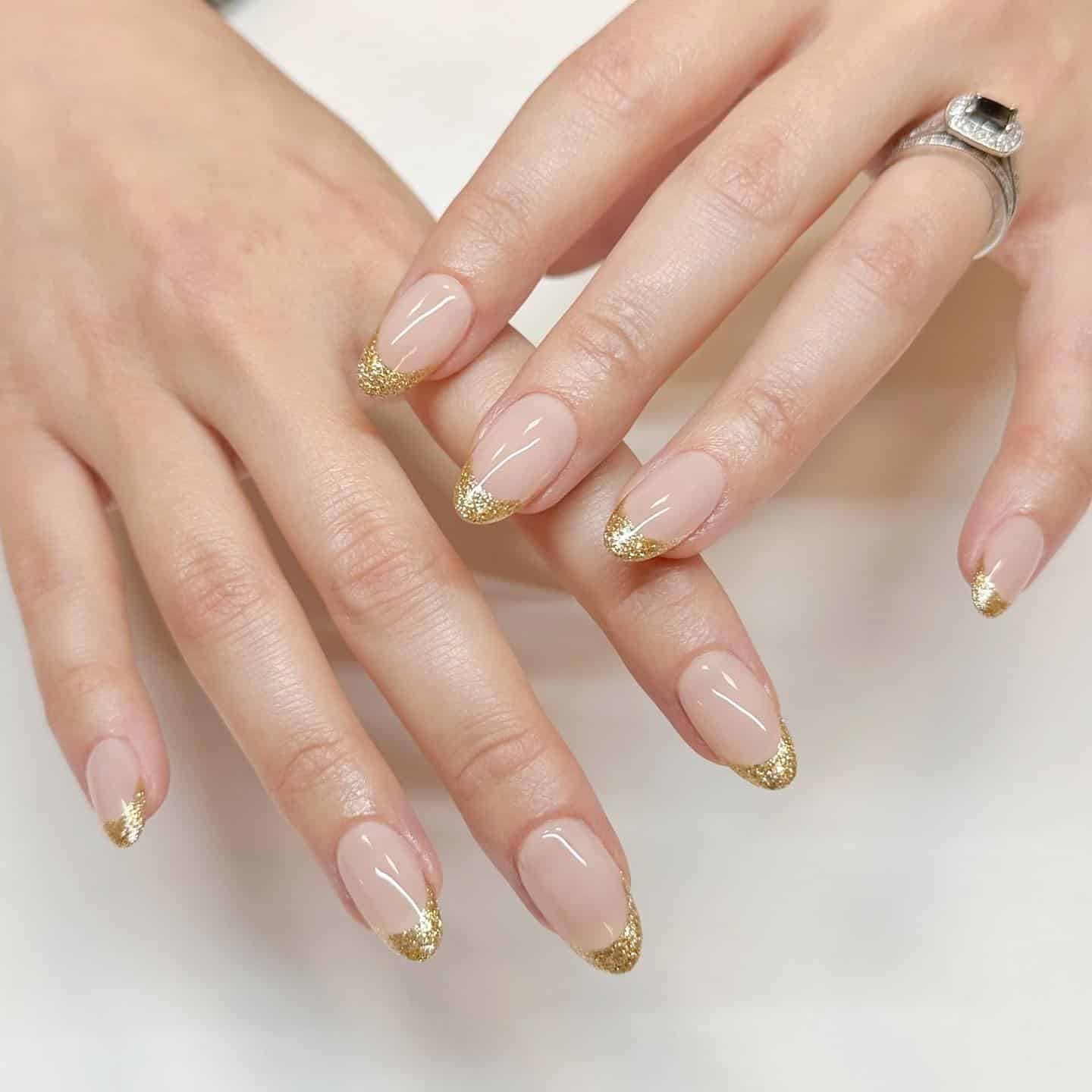 12. Creamy Beige Blonde Blowout with Gold French Almond Nails - gold glitter nail ideas