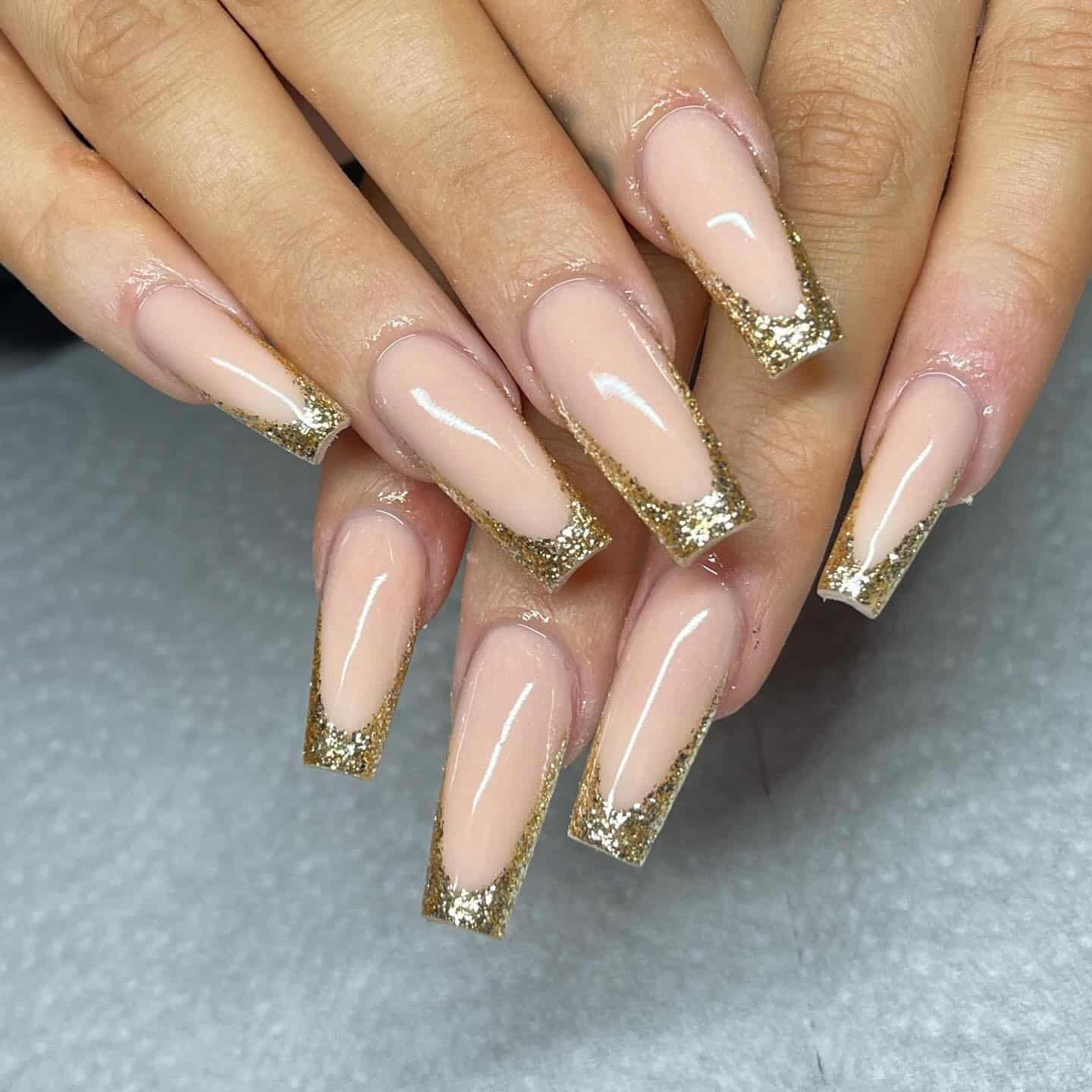 14. Warm Caramel Brunette Styling with Long Gold Glitter Coffin Nails - gold glitter nail ideas