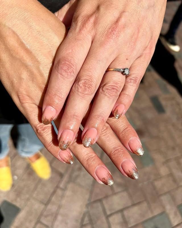 15. Sunlit Honey Brown Hair with Gold Speckled Short Nails - gold glitter nail ideas