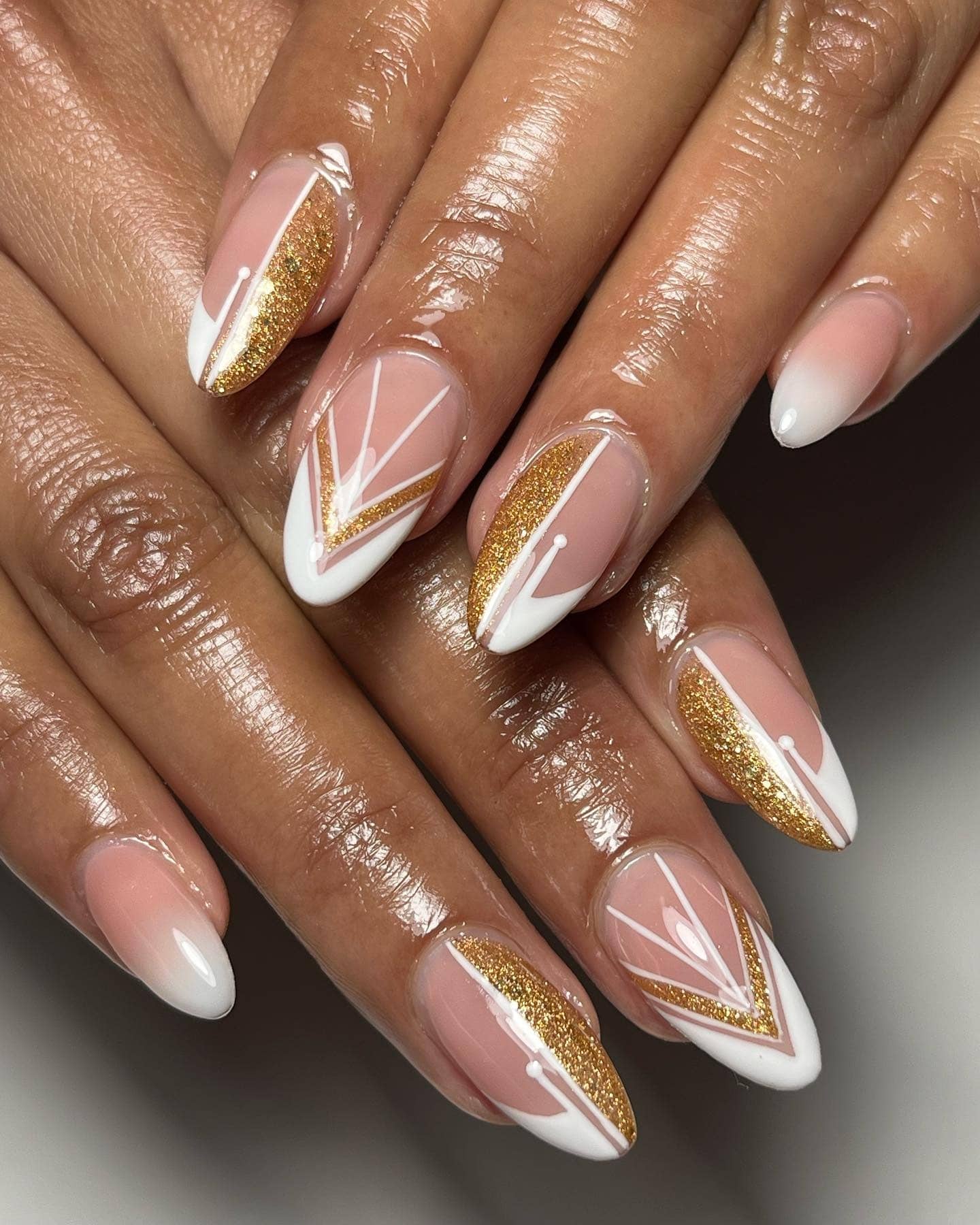 17. Rich Espresso Brown Styling with White and Gold Graphic Almond Nails - gold glitter nail ideas