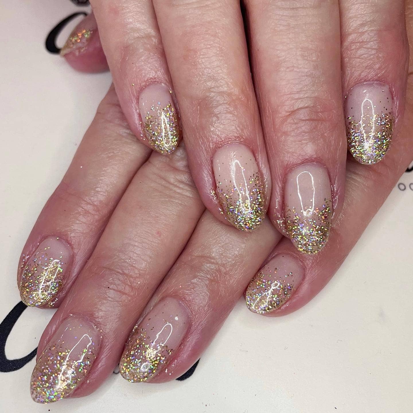 19. Sandy Blonde Blowout with Holographic Gold Glitter Fade - gold glitter nail ideas