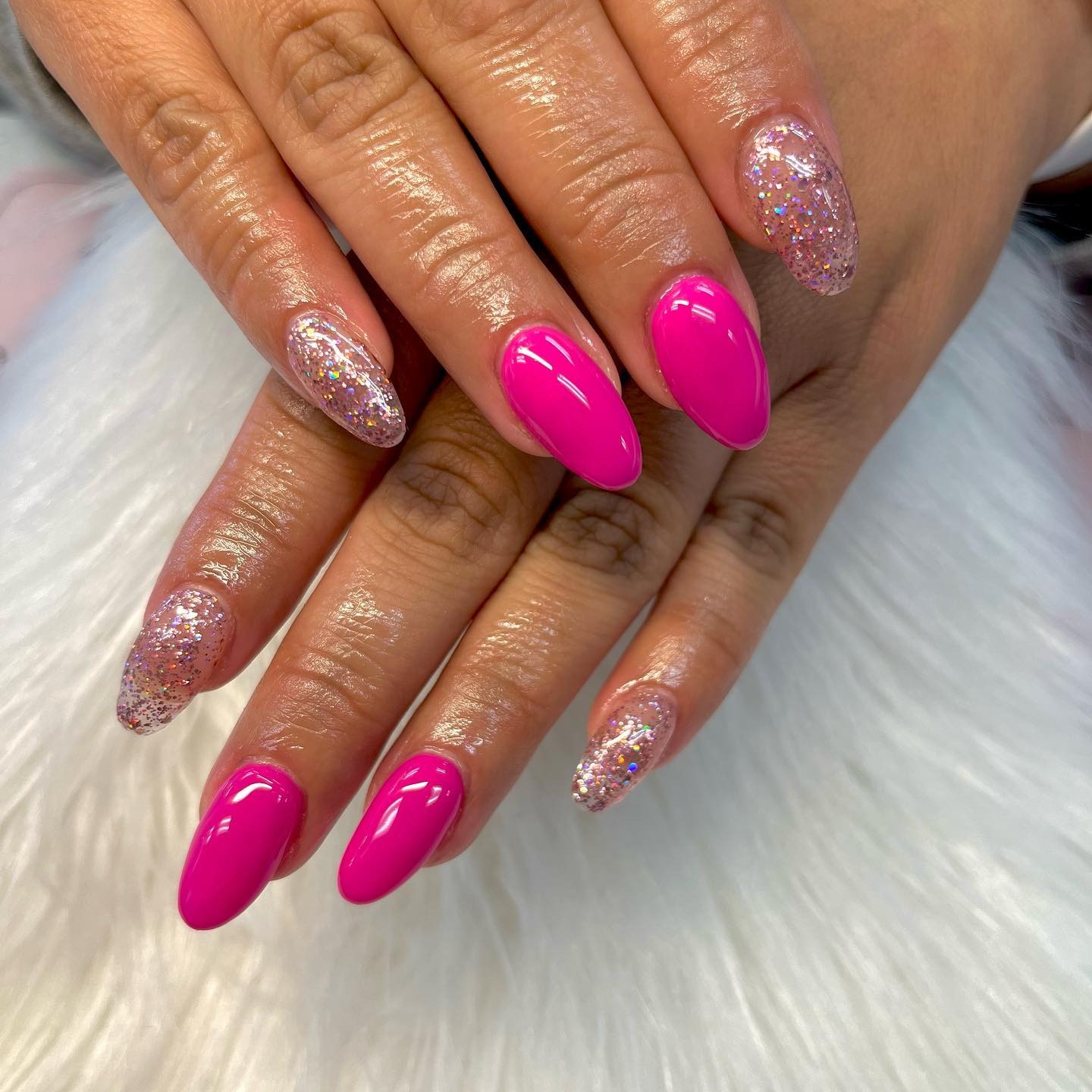 14. Solid Pink and Glitter Accent Almond Nails - hot pink almond nail ideas