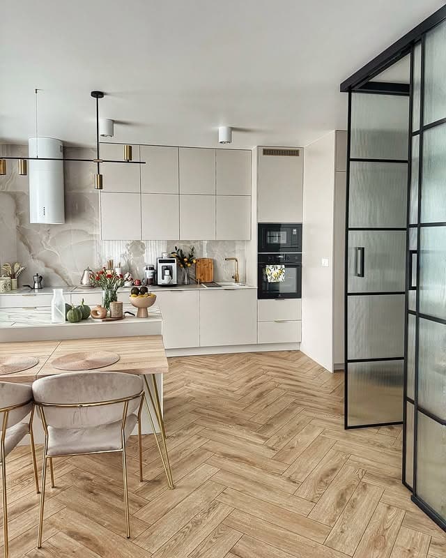 2. Contemporary Beige Kitchen with Marble Backsplash and Herringbone Floors - beige kitchen ideas