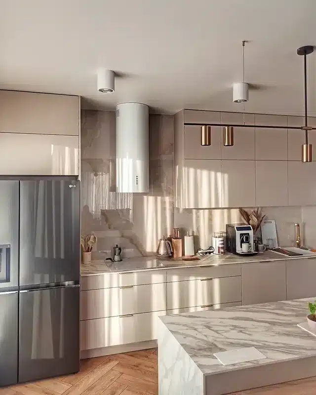 6. Glossy Beige Kitchen with Marble Island and Gold Accents - beige kitchen ideas