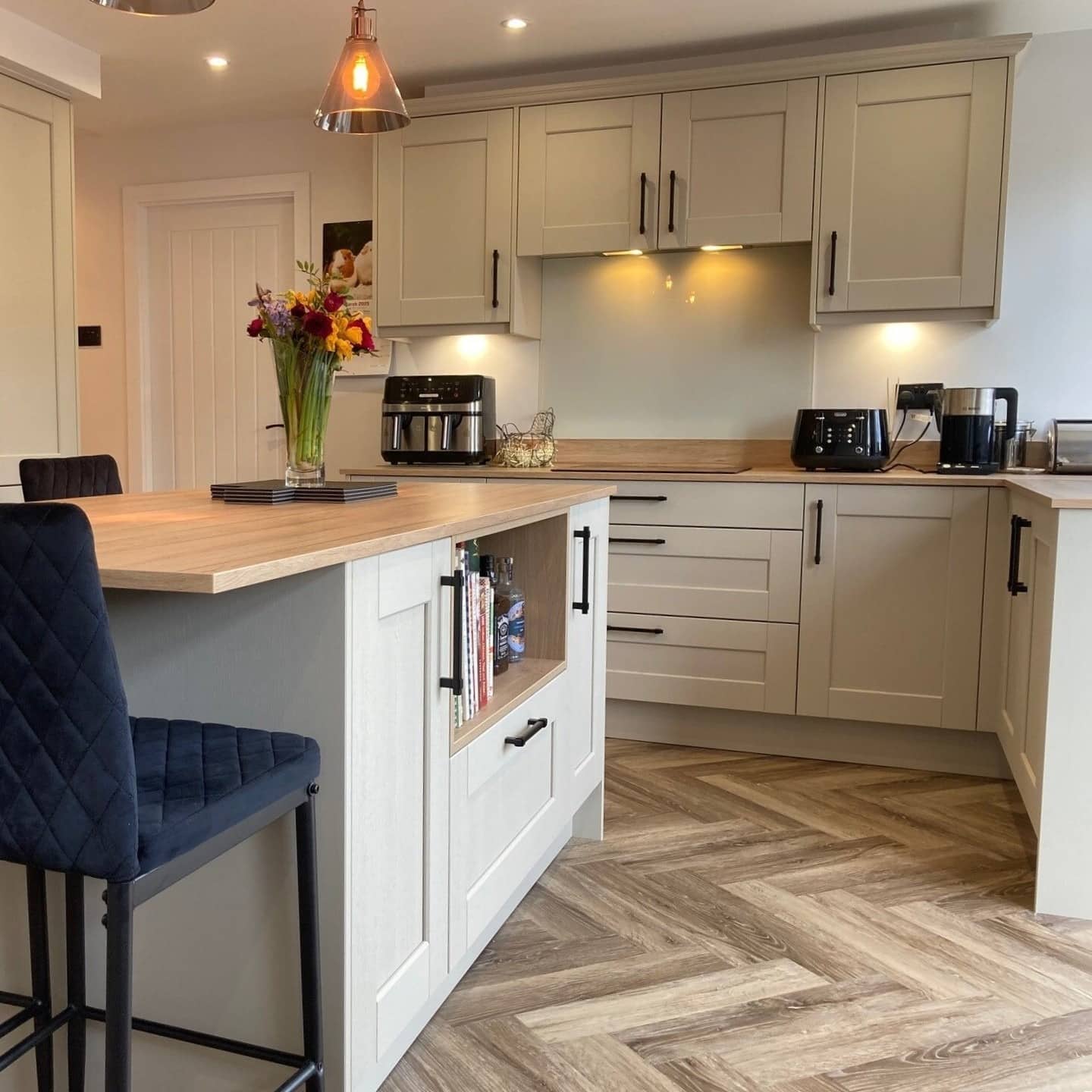 20. Warm Beige Shaker Kitchen with Herringbone Flooring - beige kitchen ideas