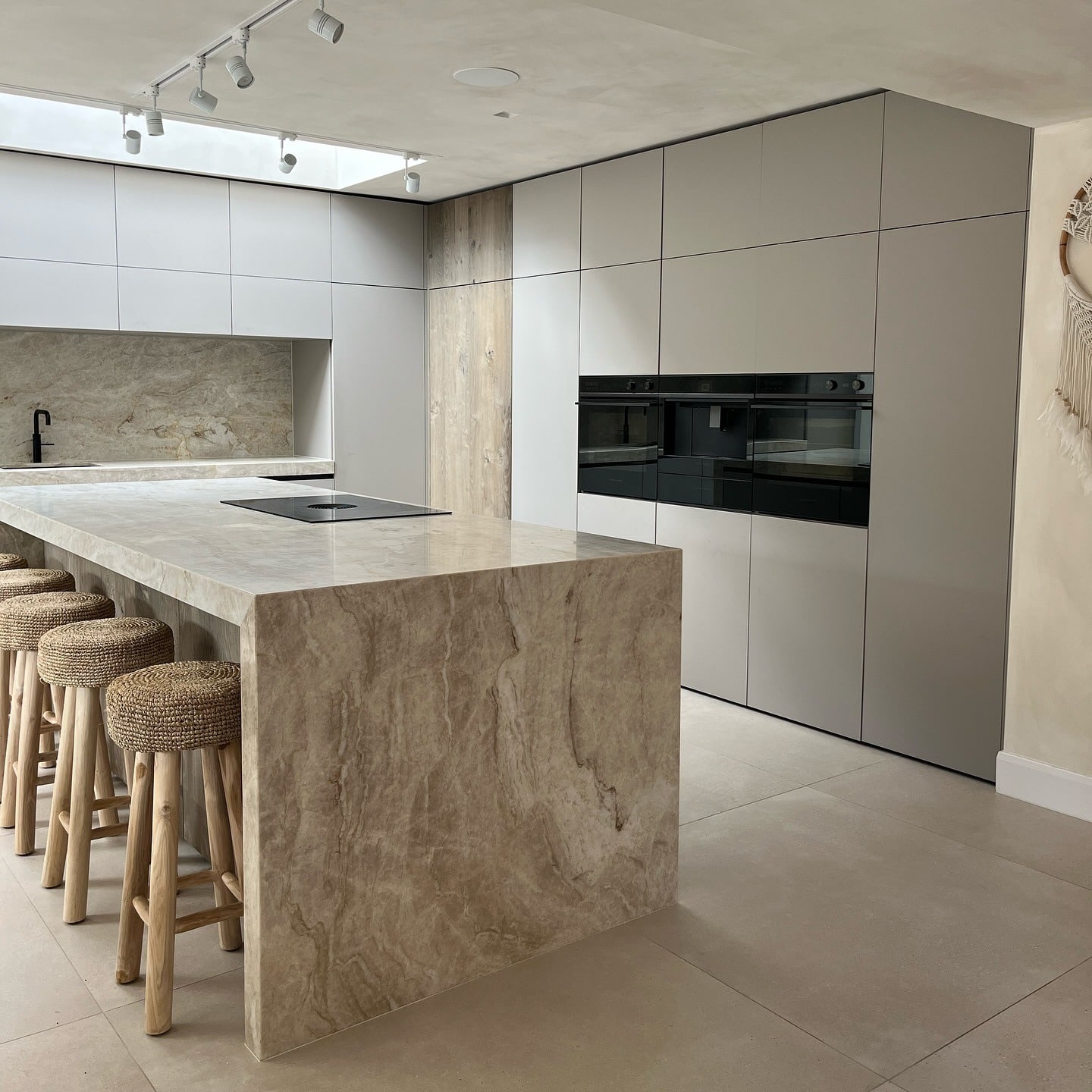21. Minimalist Beige Kitchen with Stone Waterfall Island - beige kitchen ideas