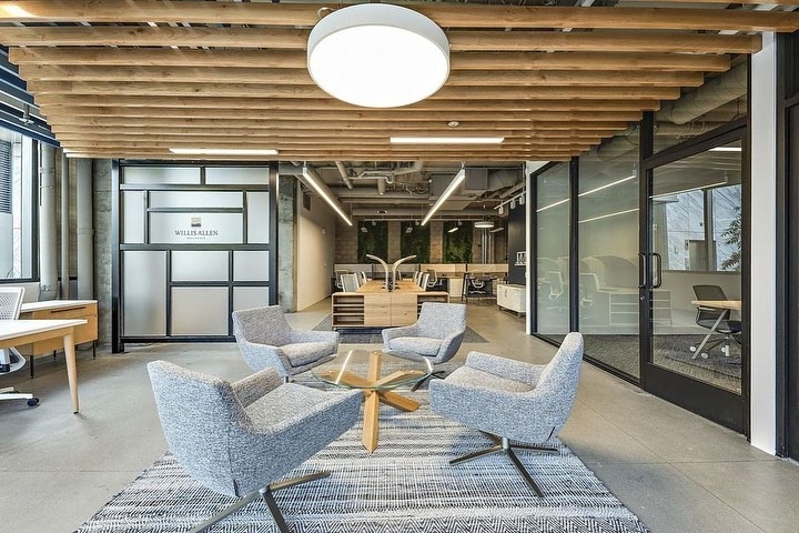 19. Industrial Greige & Warm Wood Collaboration Lounge - earth tones office ideas