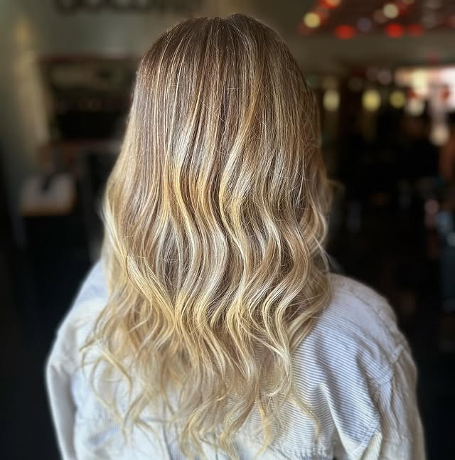 11. Soft Honey Blonde Balayage with Beach Waves - Fall Blonde Hair Color