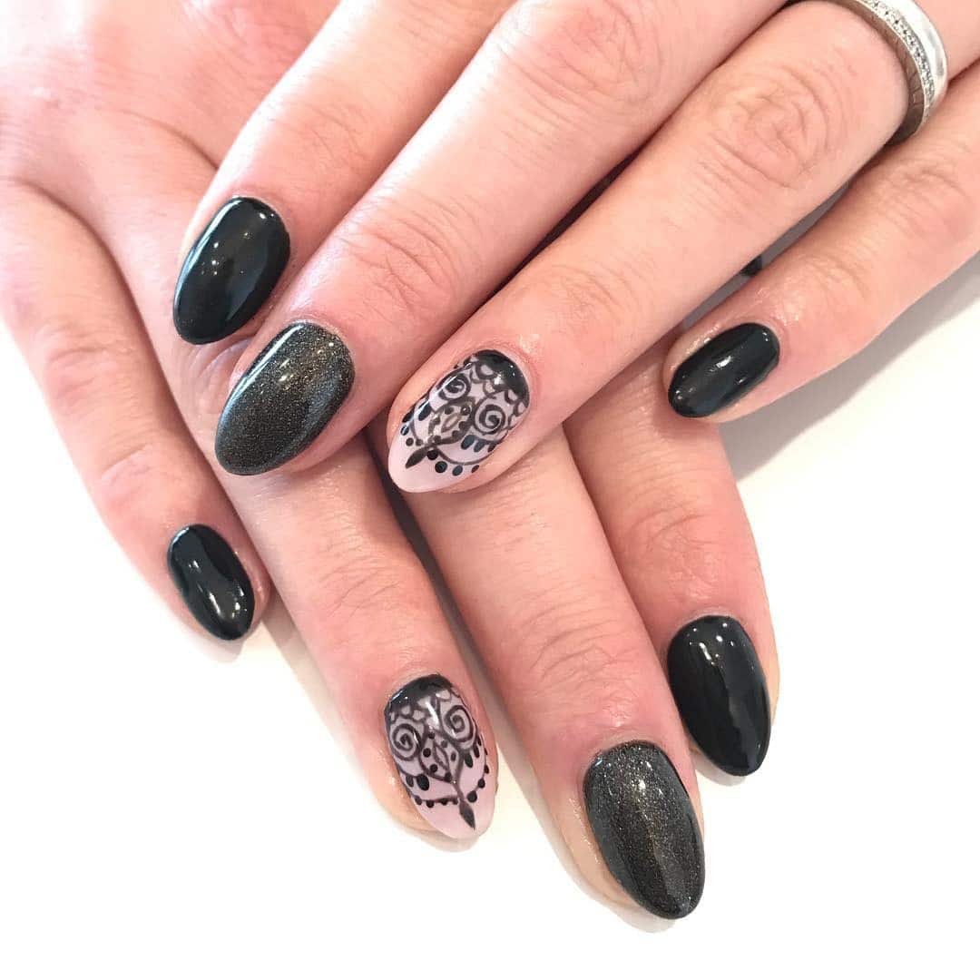 15. Glossy Black Almond Nails with Lace Accent Art - lace nail ideas