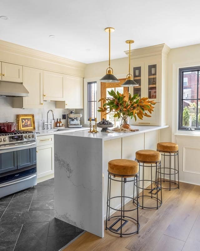 8. Creamy Traditional Kitchen with Brass and Natural Greenery - fall kitchen decor ideas