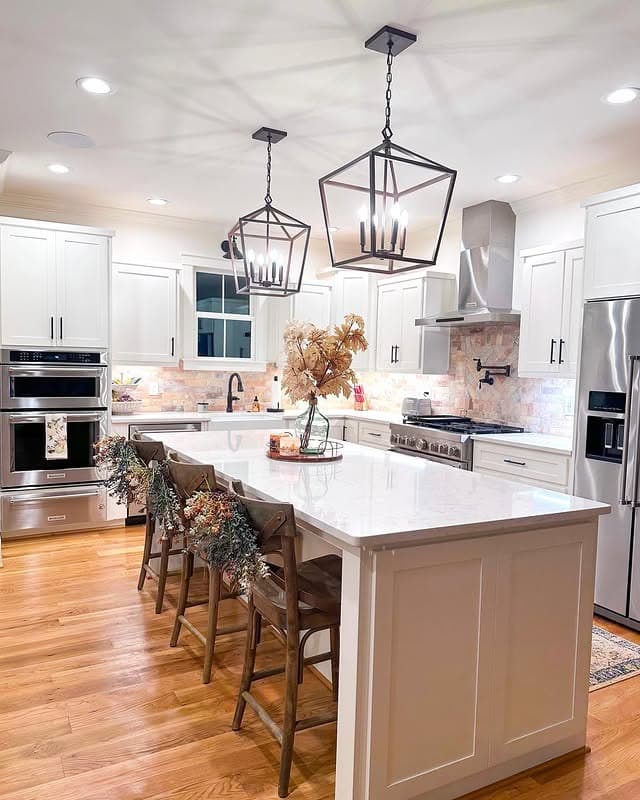 9. Bright Transitional Kitchen with Statement Lantern Pendants - fall kitchen decor ideas