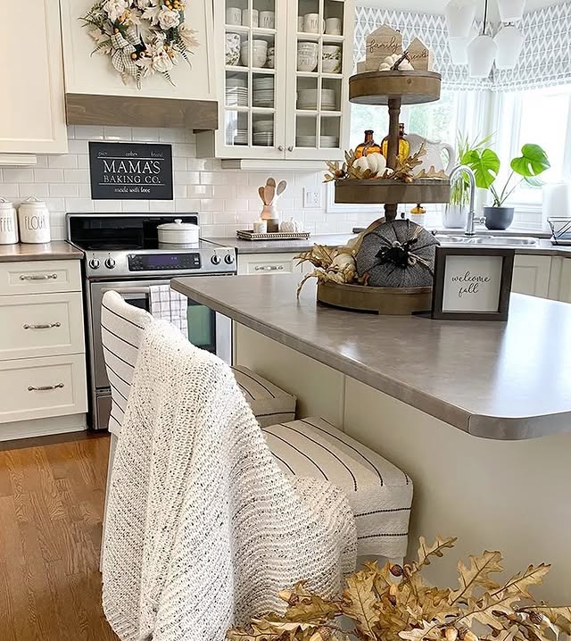 12. Creamy Farmhouse Kitchen with Soft Neutrals and Tiered Autumn Decor - fall kitchen decor ideas