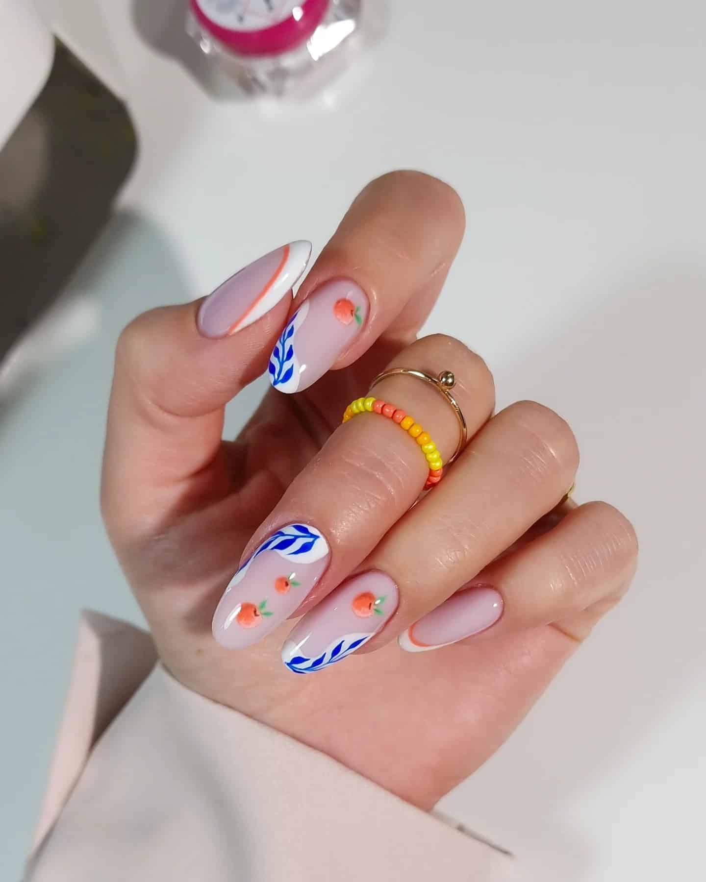 6. Minimal White Nails with Blue Leaf and Peach Accents - leaves nail ideas
