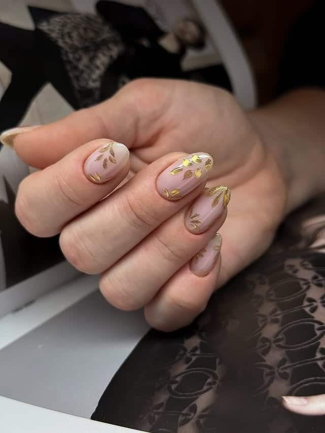 18. Sheer Nude Short Almond Nails with Gold Leaf Foil Accents - leaves nail ideas