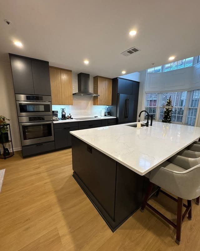 5. Two-Tone Modern Kitchen with Black Island Base - modern kitchen ideas