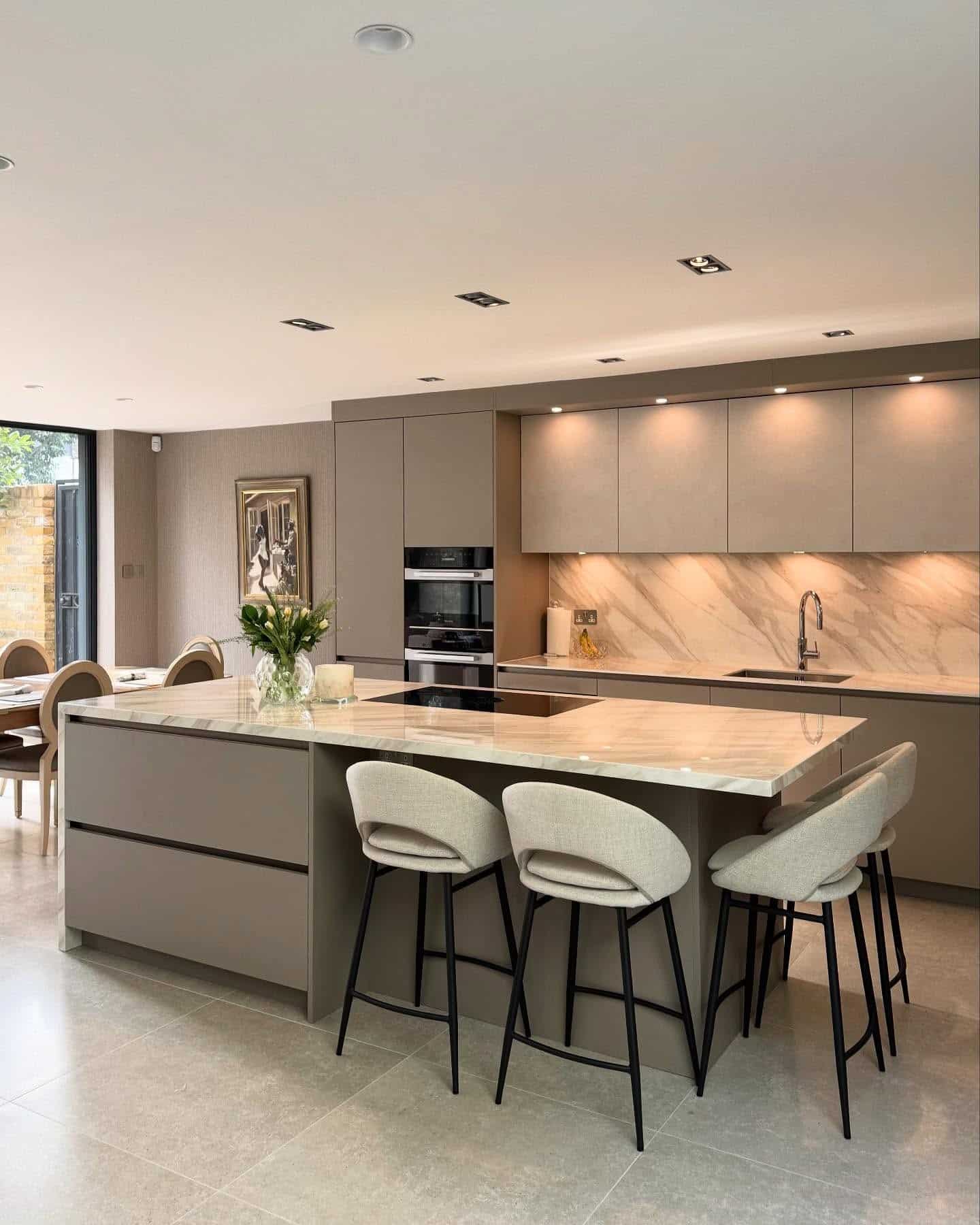 16. Neutral Modern Kitchen with Large Waterfall Island - modern kitchen ideas