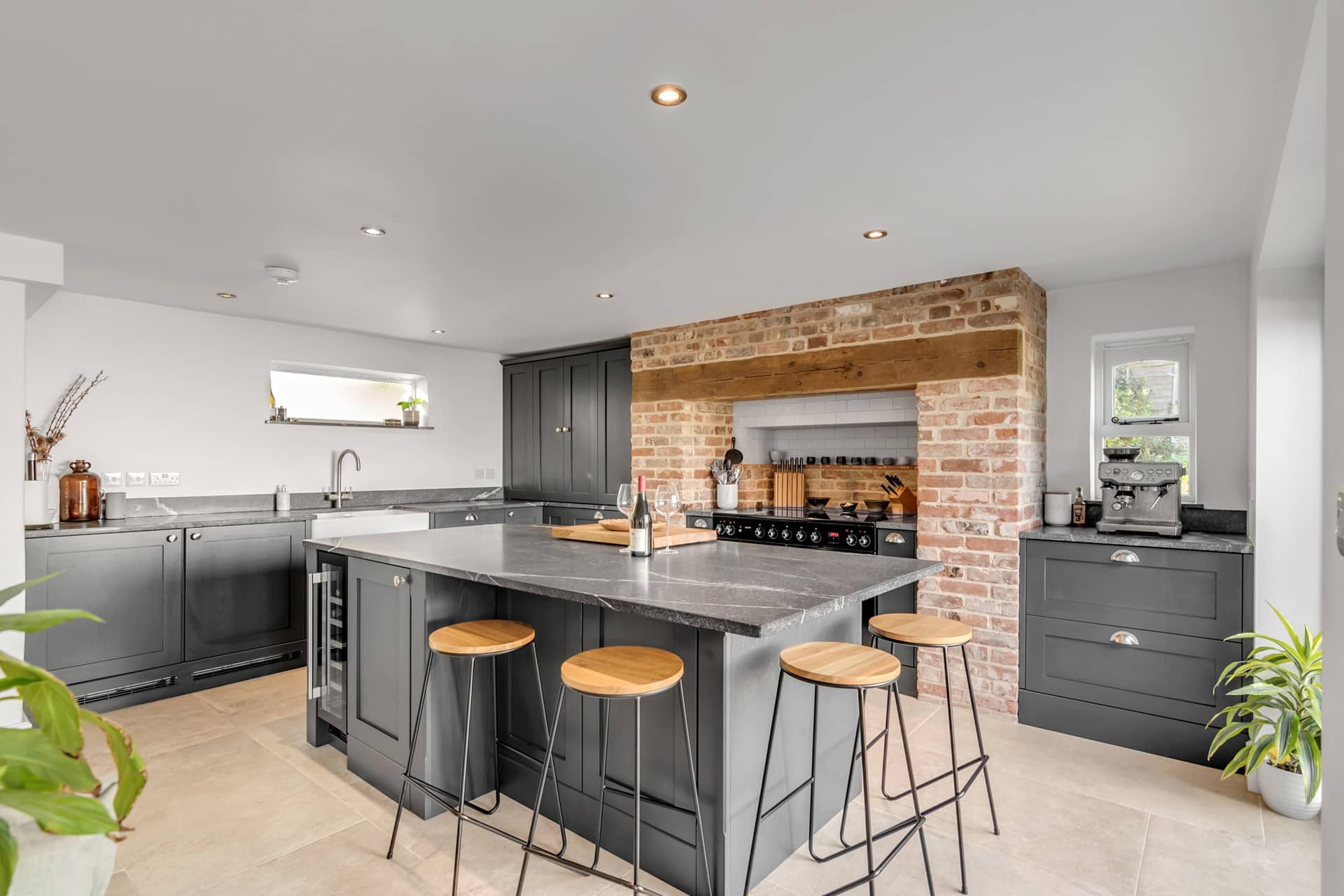 18. Industrial Inspired Kitchen with Charcoal Cabinets and Brick Feature - modern kitchen ideas