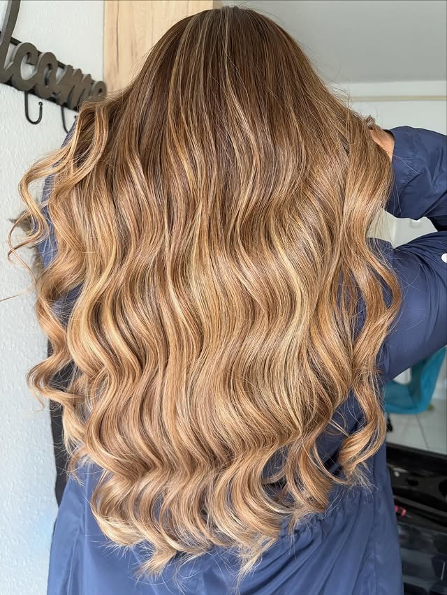 3. Golden Beige Balayage on Long Layered Waves - Blonde Brown Hair Color