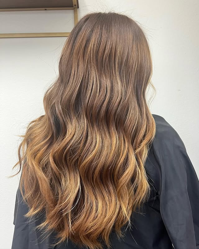 13. Golden Brown Balayage on Soft Waves - Blonde Brown Hair Color