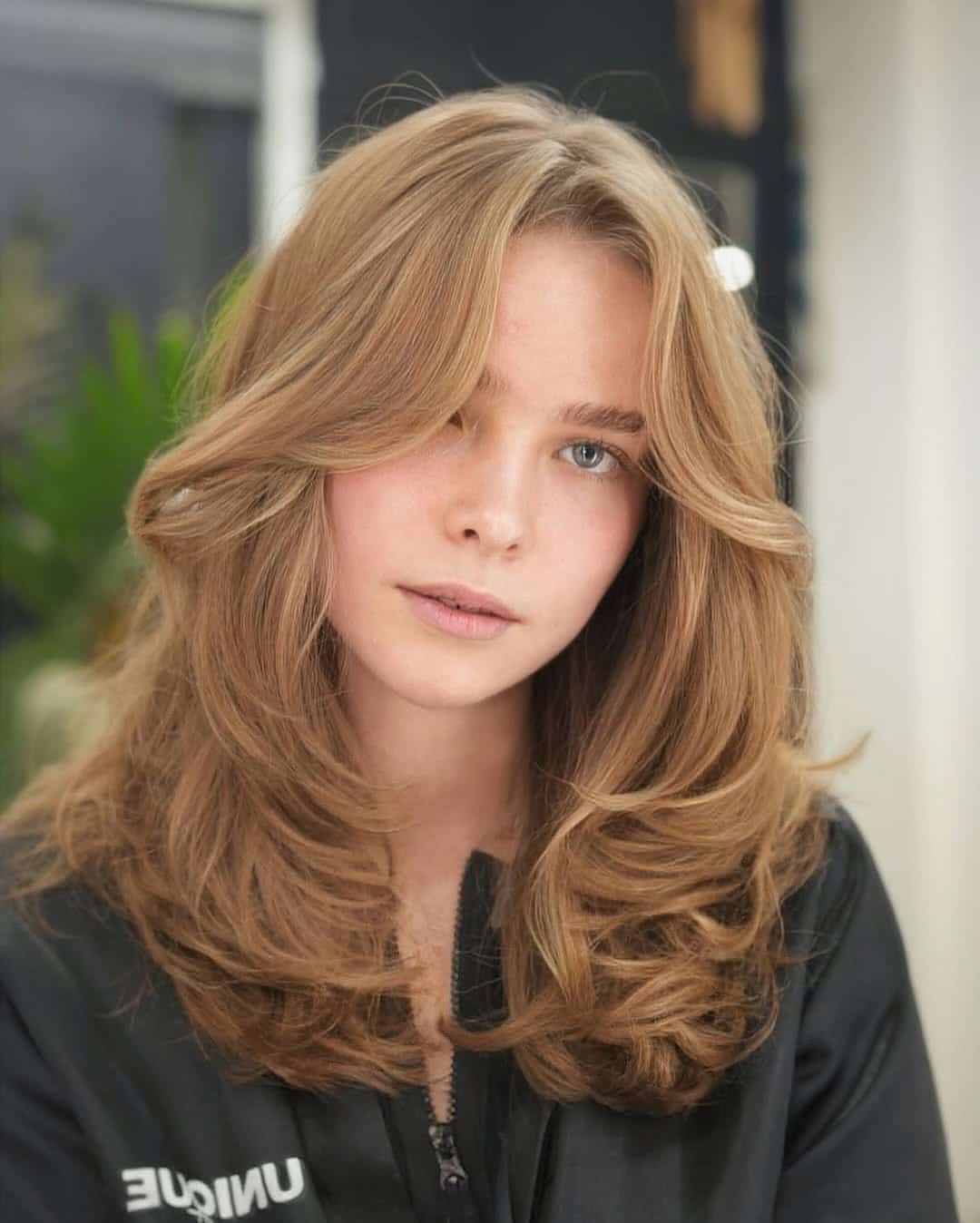 7. Polished Medium Blowout Layers with Caramel Brown Bangs - Medium Haircuts With Bangs