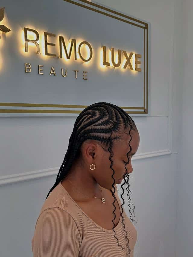 18. Swirl Pattern Cornrow Braids with Curly Tendrils in Natural Black - Cornrow Hairstyles