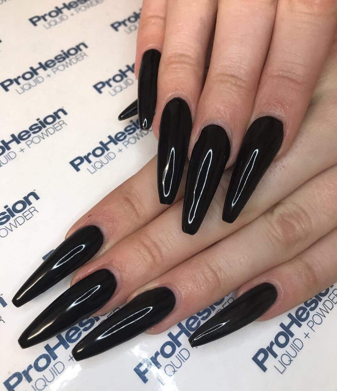 2. High-Gloss Black Stiletto Nails - long black nail ideas