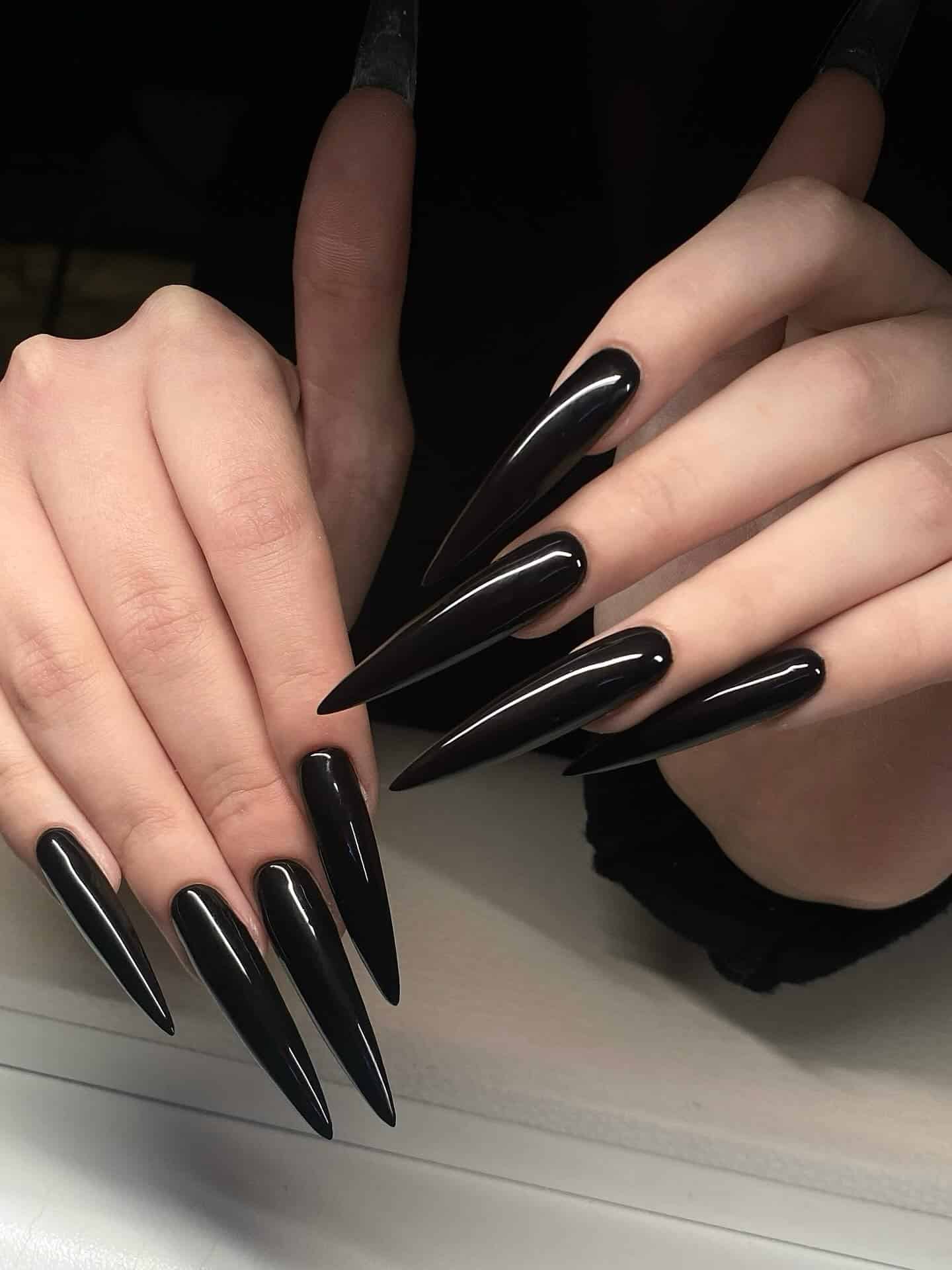 5. Dramatic Ultra-Long Black Stiletto Nails - long black nail ideas