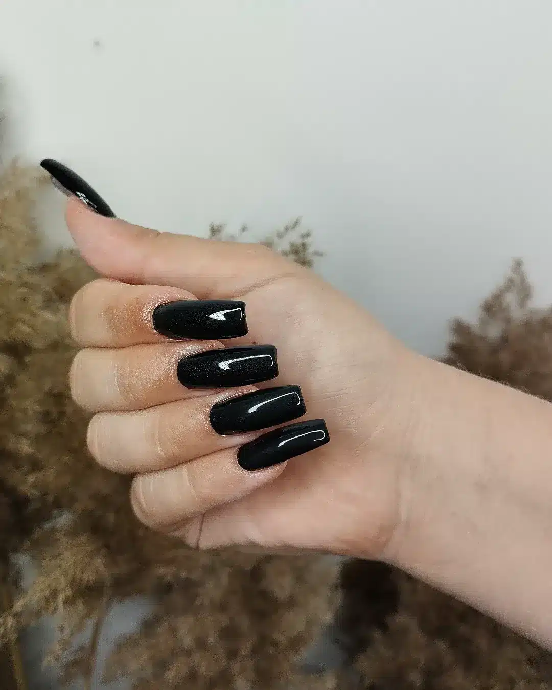 6. Glossy Black Medium Square Nails - long black nail ideas