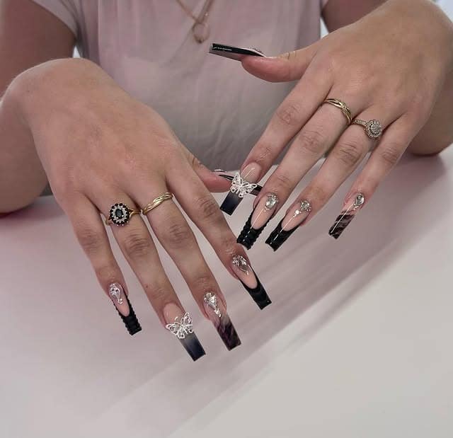 7. Long Square Black French Tip with Charms - long black nail ideas