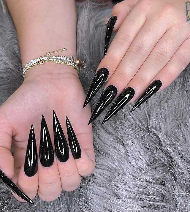 18. Extra Long Glossy Black Stiletto Nails - long black nail ideas