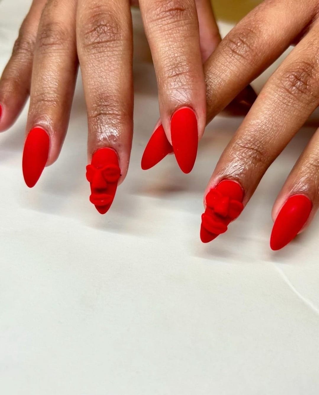 4. Sculpted Matte Red Stiletto Nails with 3D Floral Art - matte red nail ideas
