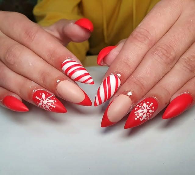 11. Matte Red Stiletto Nails with Candy Cane Stripes and Snowflake Art - matte red nail ideas