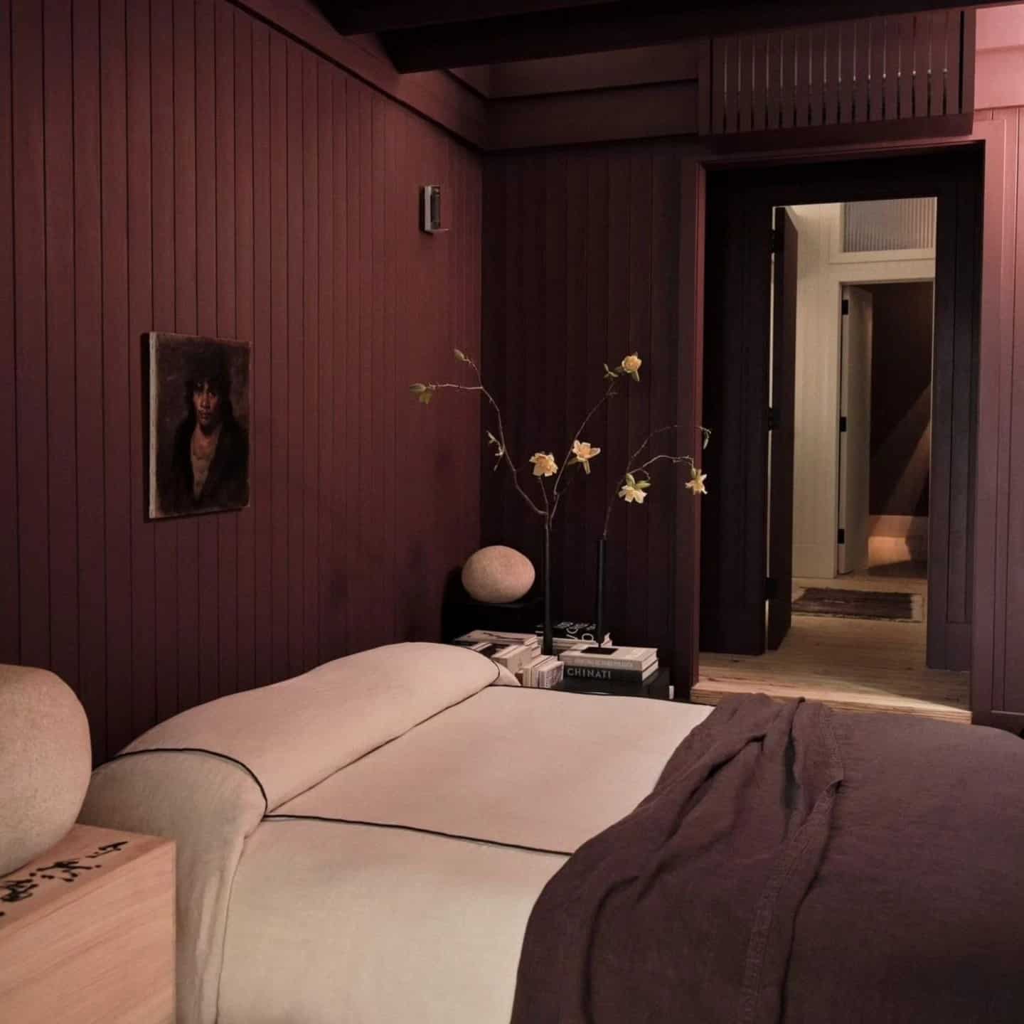 21. Deep Burgundy Wood Paneled Bedroom with Minimalist Styling - moody bedroom ideas