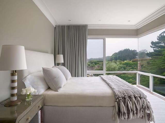 10. Light-Filled Bedroom with Expansive Corner Windows - serene bedroom ideas