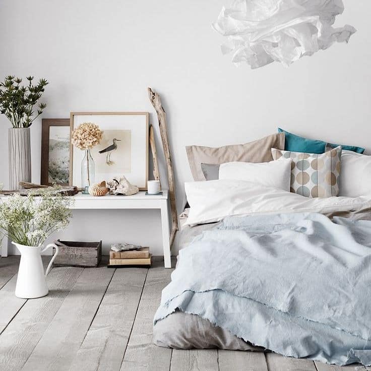 16. Scandinavian Inspired Bedroom with Soft Blue Linen Bedding - serene bedroom ideas