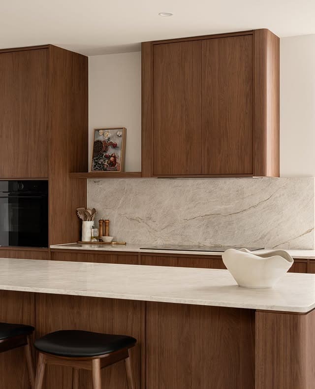 12. Minimal Walnut Kitchen with Stone Backsplash - brown kitchen ideas