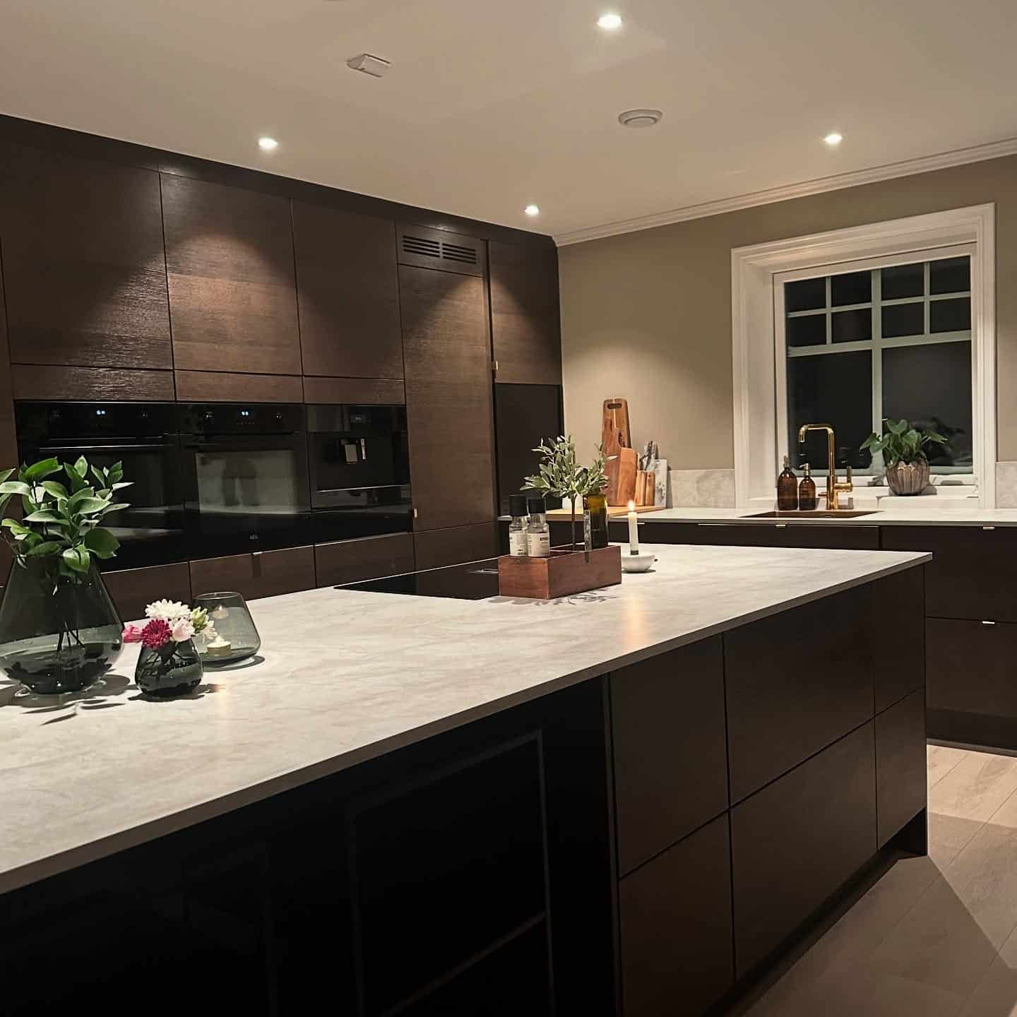 17. Modern Dark Brown Kitchen with Integrated Appliances - brown kitchen ideas