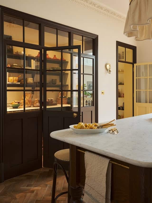 21. Classic Dark Brown Kitchen with Glass Pantry Doors - brown kitchen ideas