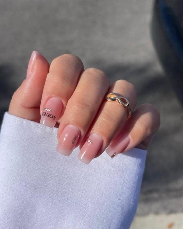 6. Sheer Pink Square Nails with Minimal Text and Crystal Accents - minimalist nail ideas