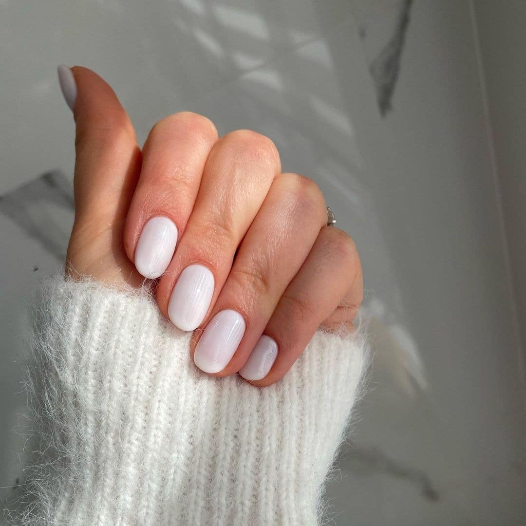 15. Soft White Short Oval Nails with Glossy Minimal Finish - minimalist nail ideas