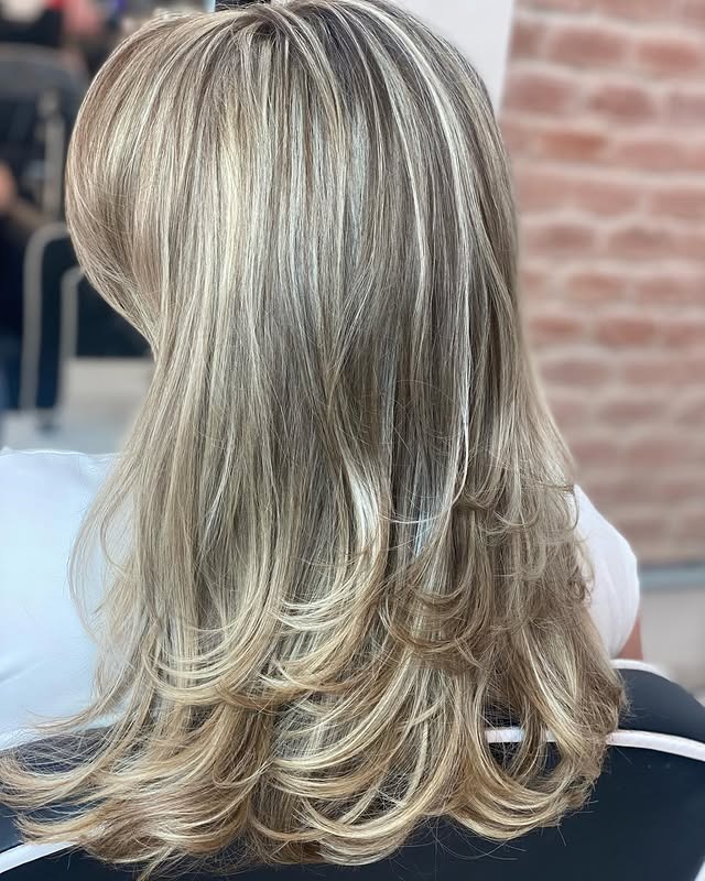 10. Ash Blonde Layered Cut with Airy Movement - Light Hair Color