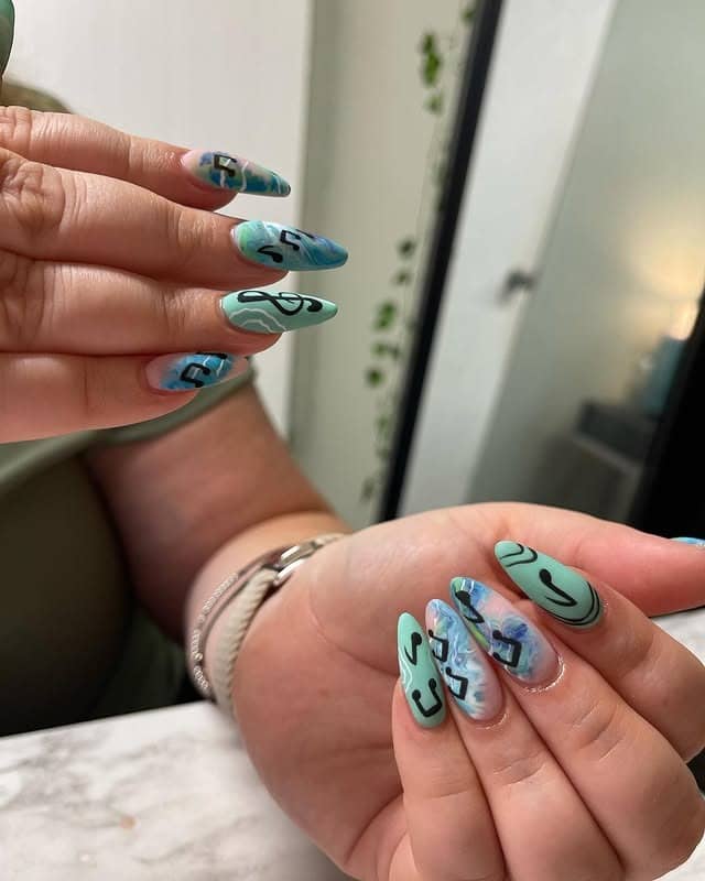 12. Teal Marble Music Note Almond Nails - music nail ideas