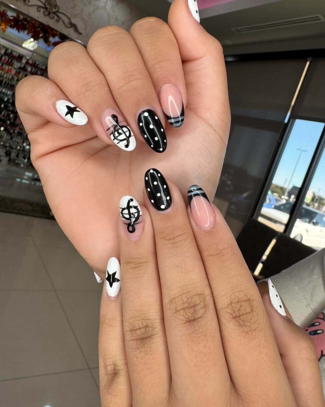 22. Black and White Music Note Almond Nails with Polka Dots - music nail ideas