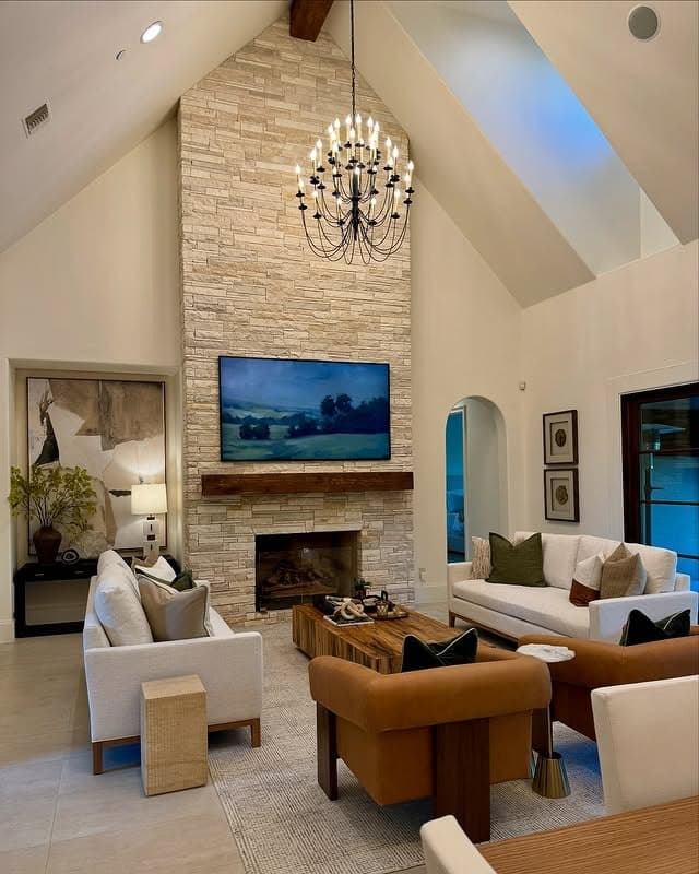 4. Stone Fireplace Living Room with Warm Tan and Cream Palette - earth tones living room ideas