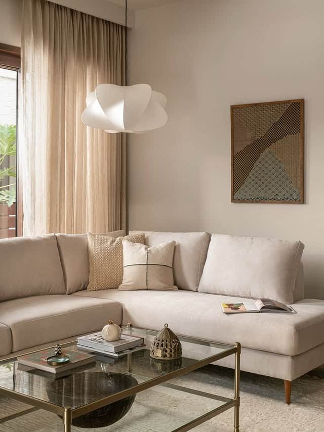 9. Minimal Earth Tone Living Room with Soft Cream Layers - earth tones living room ideas