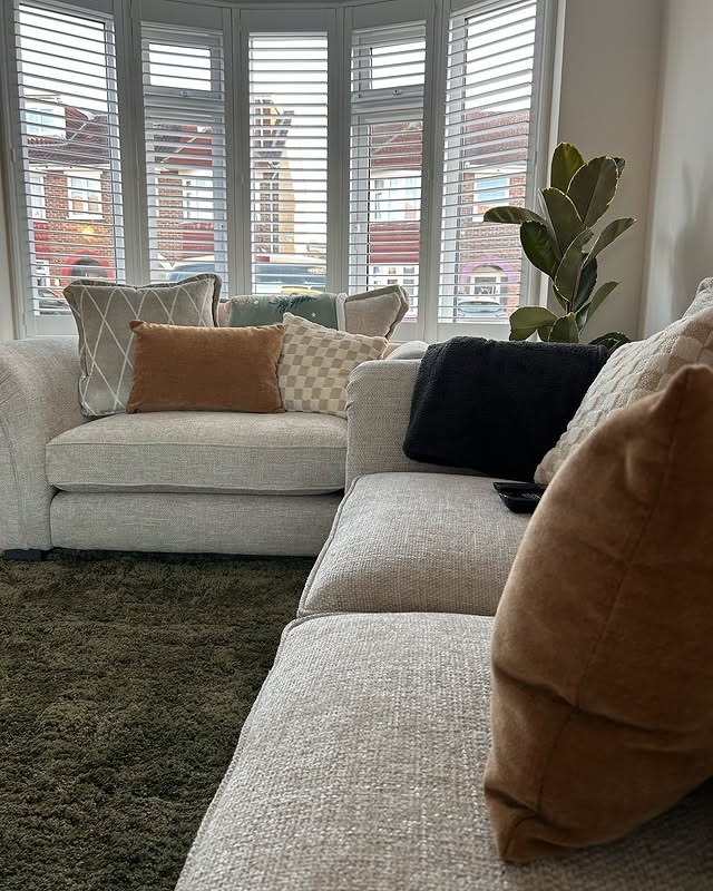 18. Neutral Window Nook Living Room with Soft Brown Accents - earth tones living room ideas